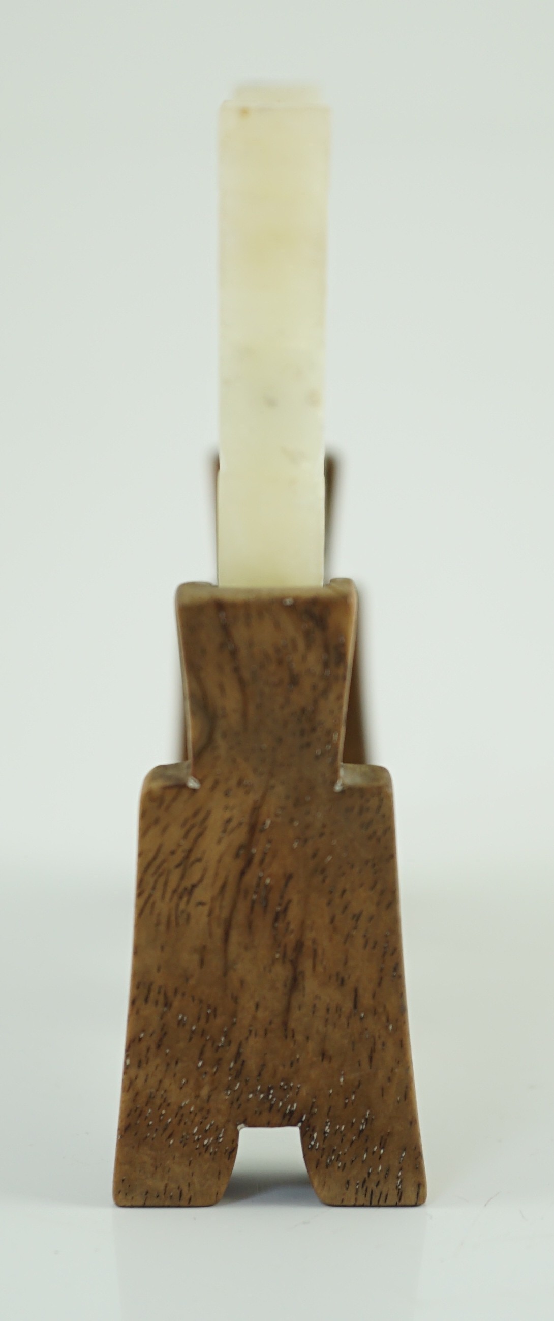 A Chinese speckled white jade ‘lock’ pendant plaque, 19th/20th century, 7.6cm x 5.8cm, wood stand